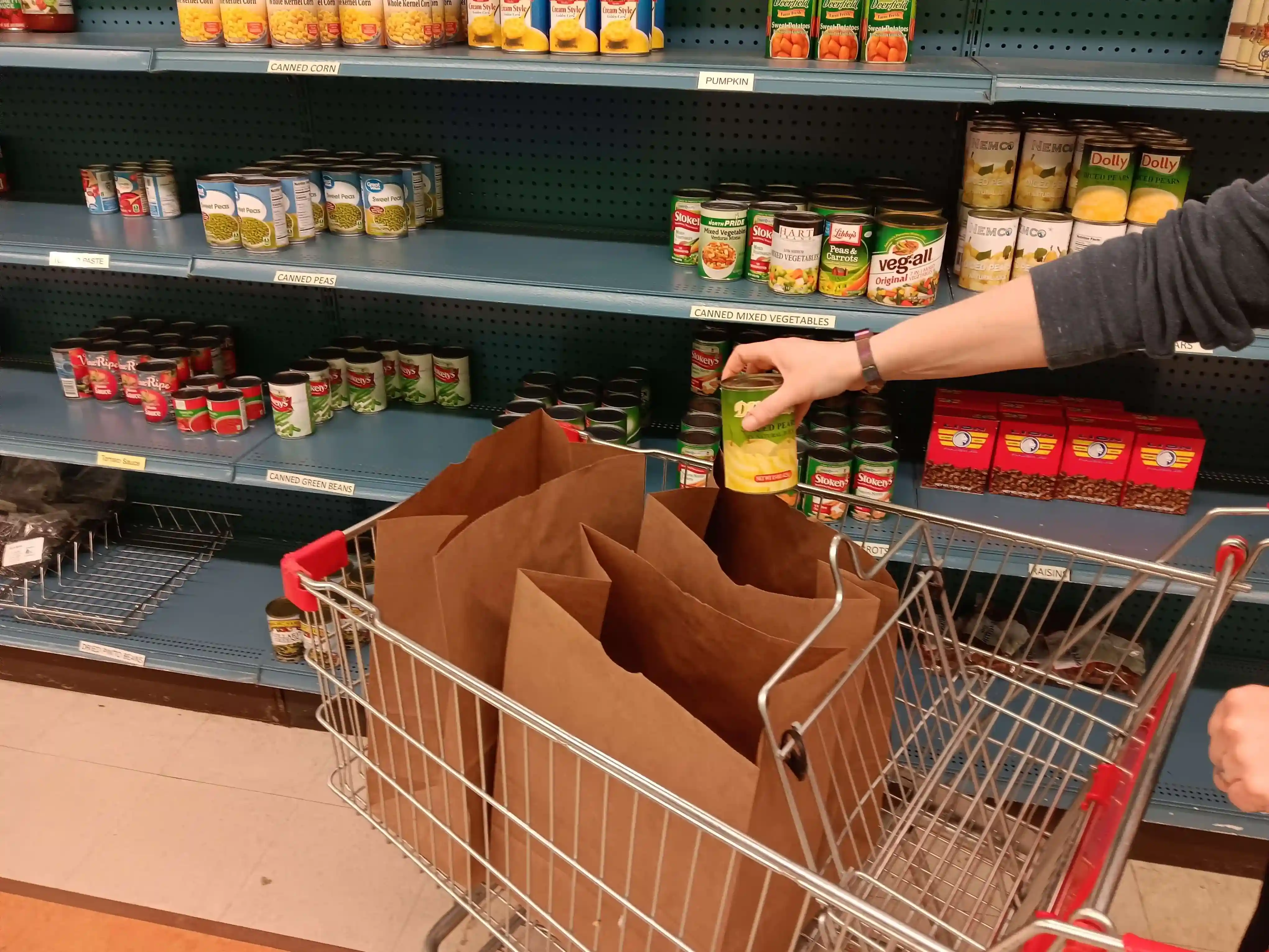 A cart with food in someone's hand